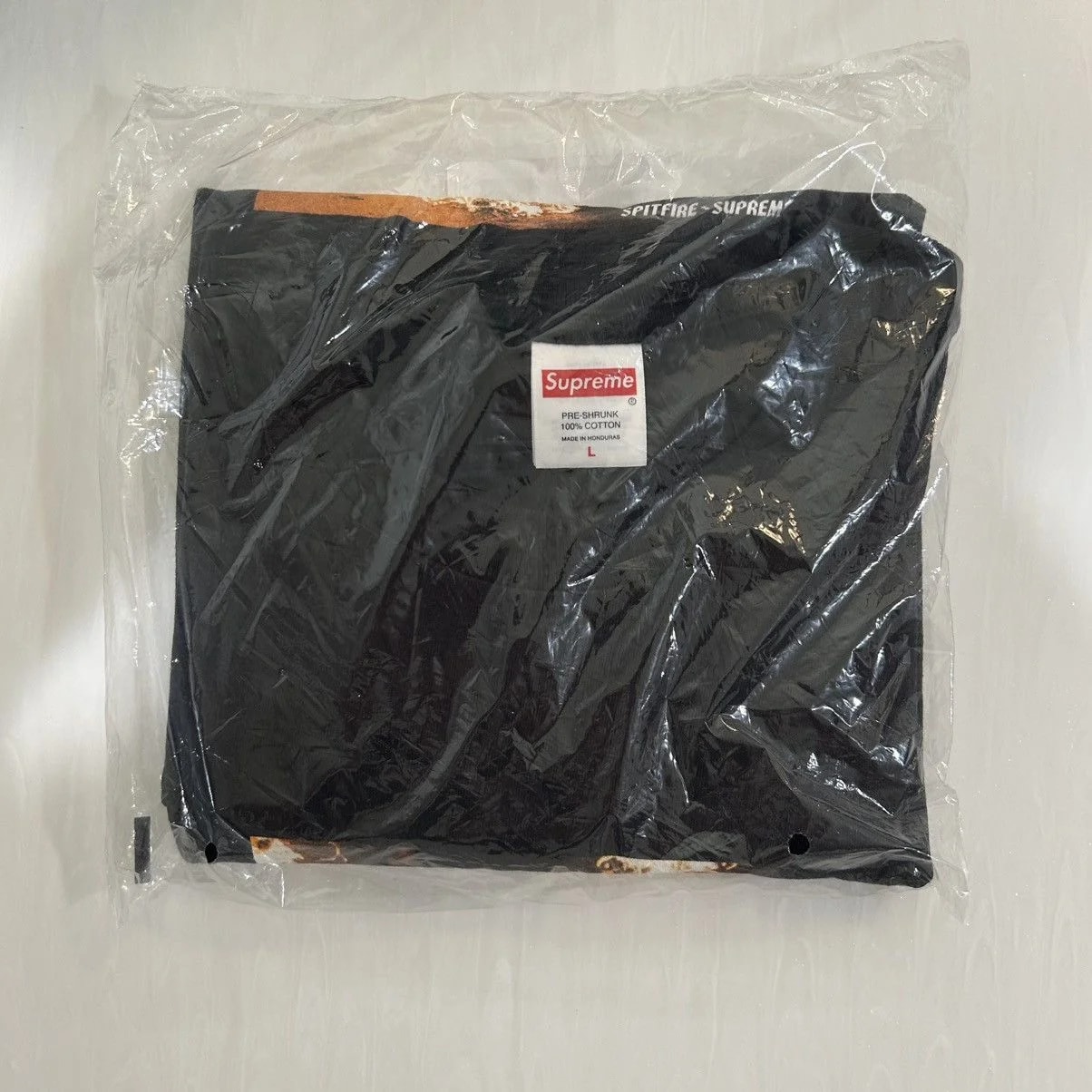 Supreme — Supreme X Spitfire Flag Tee — streetwear — resale