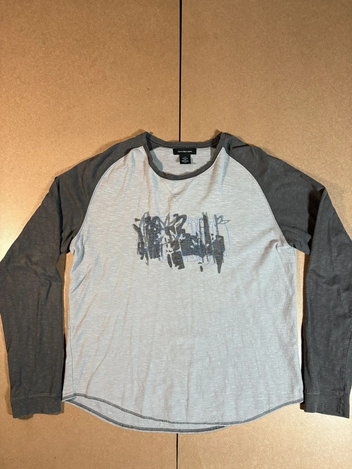 Calvin Klein — Calvin Klein Jeans Graphic Raglan Long Sleeve Tee L — streetwear — resale