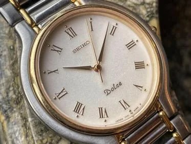 Seiko — Seiko Dolce Roman ‘Grain Sprinkle’ | Ref. 7741-6050 | Two Tone Case | Two Tone H Bracelet | Grainy White Dial ✨ | Applied Roman Numerals | Anti-Magnetic 🧲 | 34mm | January 1989 🗓️ | Birth Year 🎂 | 250$ Global Tracked Shipping ✈️ — Watch — resale